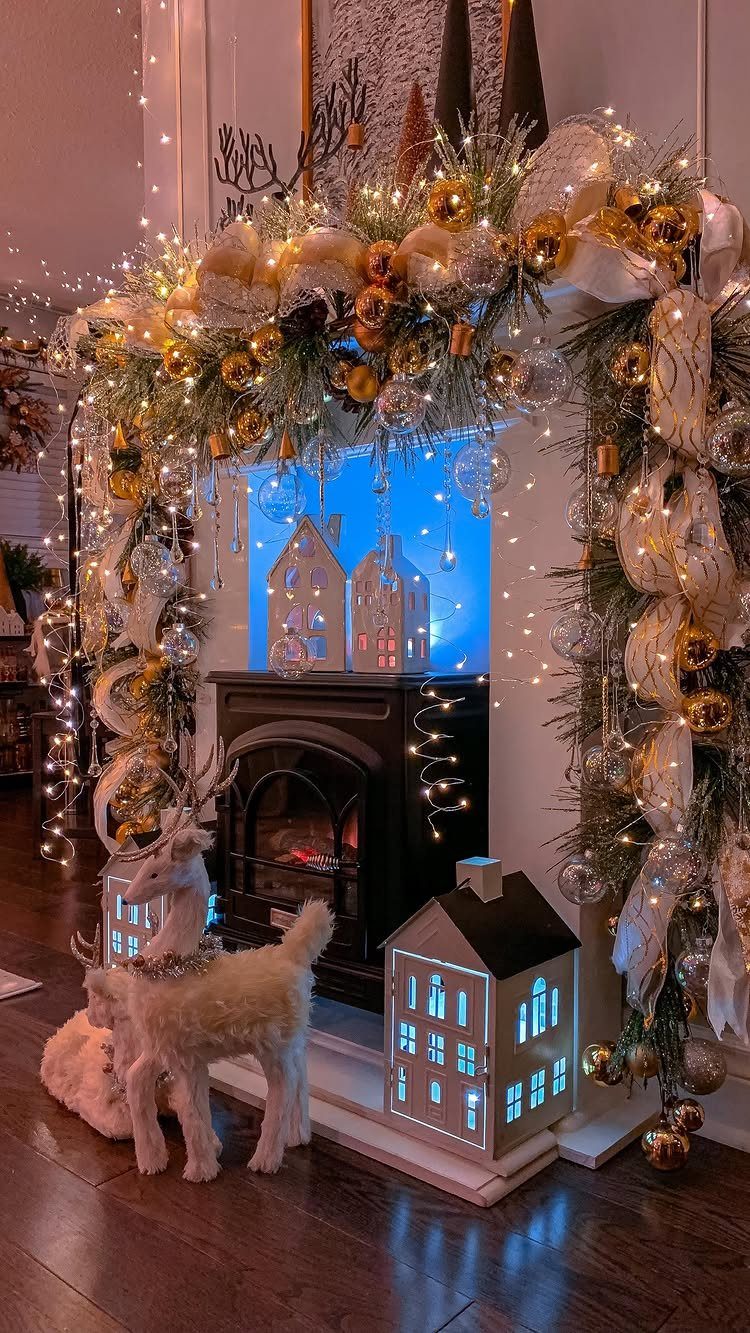 Decorated fireplace mantel with gold ornaments, white ribbons, fairy lights, and hanging crystal beads.