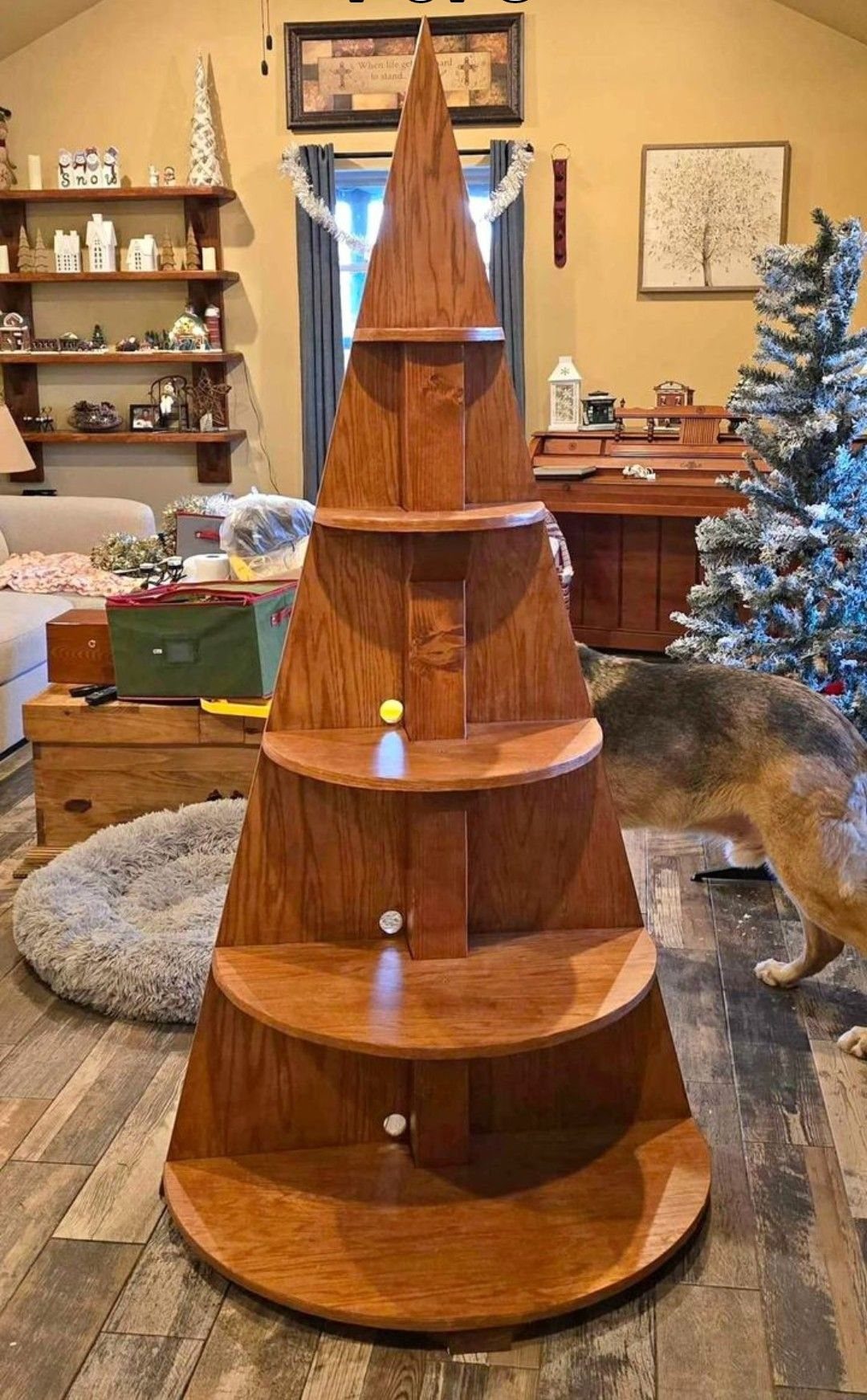 Christmas Tree Shelf: 6 Ideas from 2x4 Builds to Live Edge 4 A large wooden tree-shaped shelf with multiple curved tiers standing on a wooden floor.