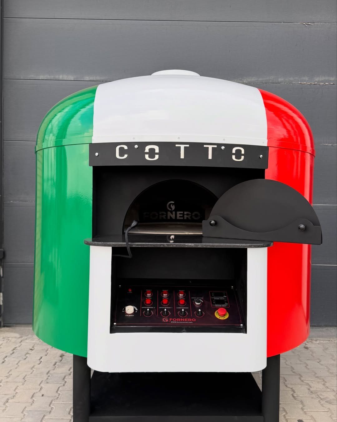 A large outdoor pizza oven painted with the green, white, and red colors of Italy.