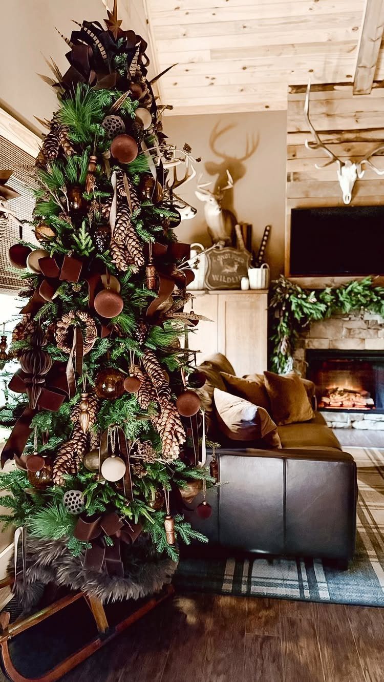 A decorated Christmas tree with rustic brown ornaments and pinecones in a cozy living room.