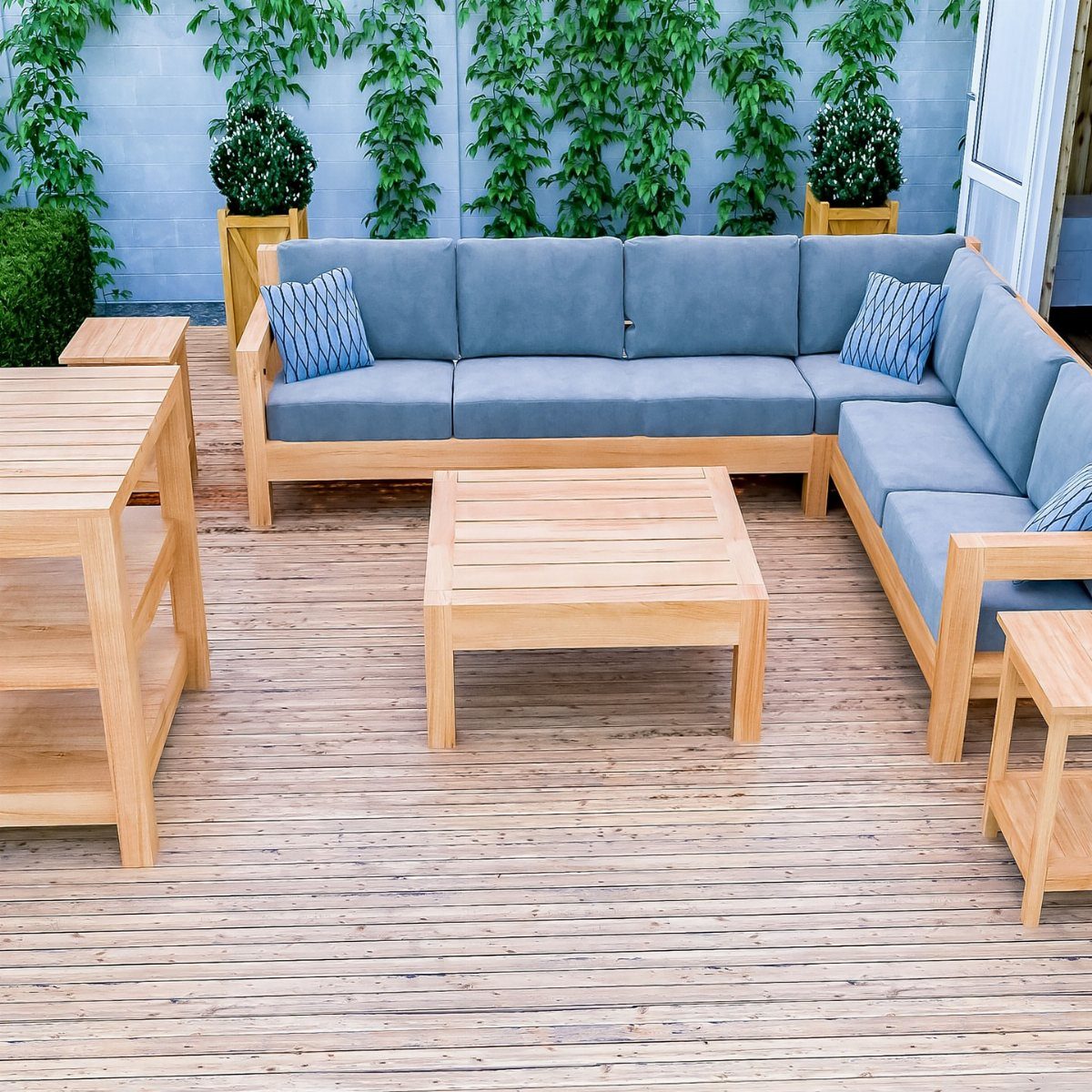 DIY Patio Couch: 8 Projects to Build for Any Budget 1 Light wood outdoor sectional sofa with blue cushions on a wooden deck with a coffee table.
