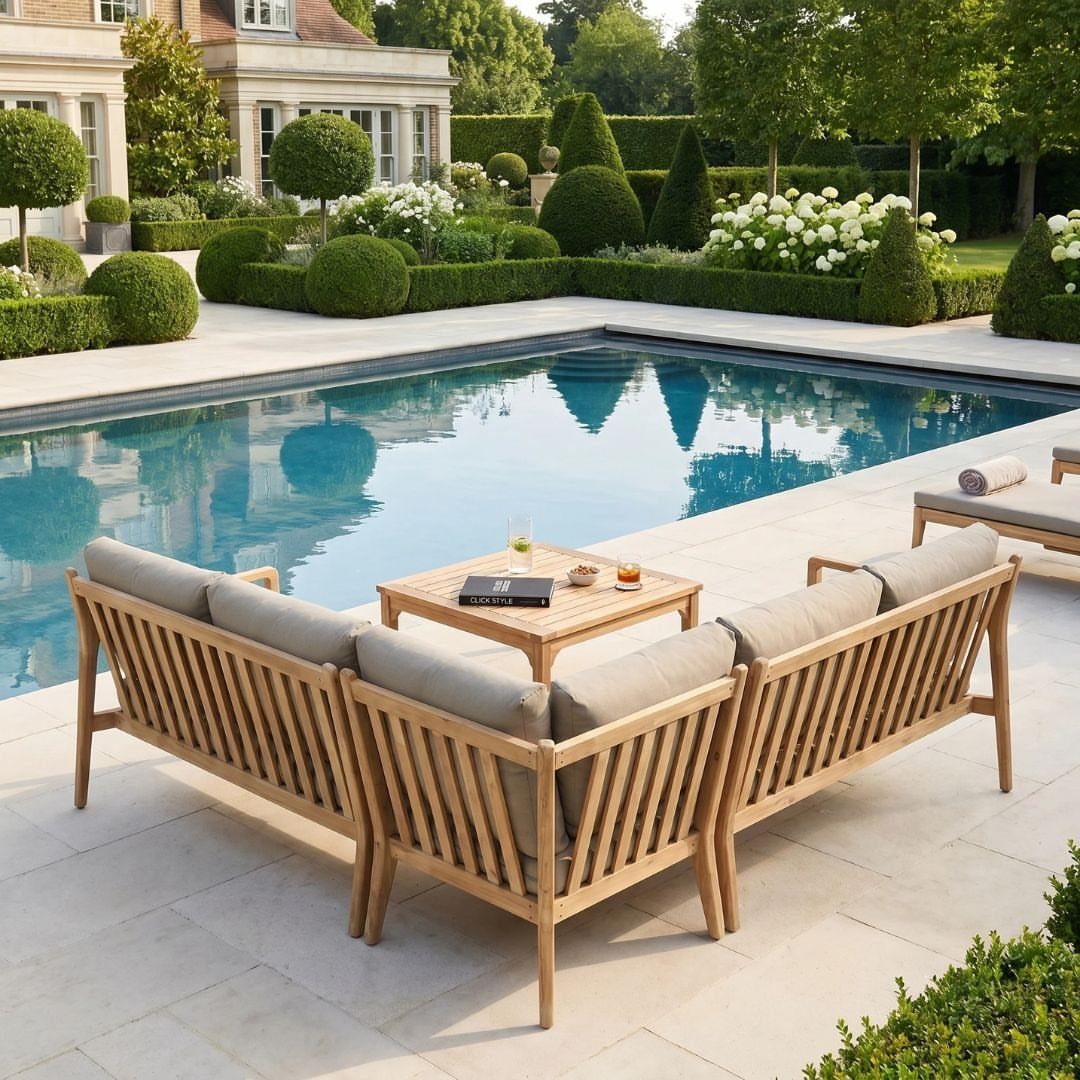 DIY Patio Couch: 8 Projects to Build for Any Budget 8 Wooden outdoor sectional sofa with grey cushions arranged around a coffee table by a swimming pool.