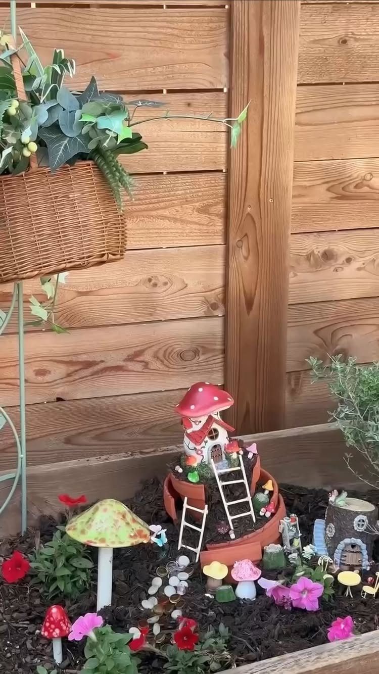 Easy Garden DIY: 18 Projects for a Yard That Feels Finished 3 Miniature mushroom houses and tiny figurines arranged in a small garden planter box.