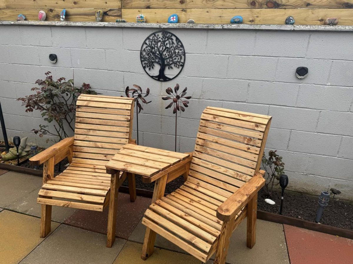 Easy Garden DIY: 18 Projects for a Yard That Feels Finished 1 Two wooden lounge chairs and a small wooden side table on a patio.