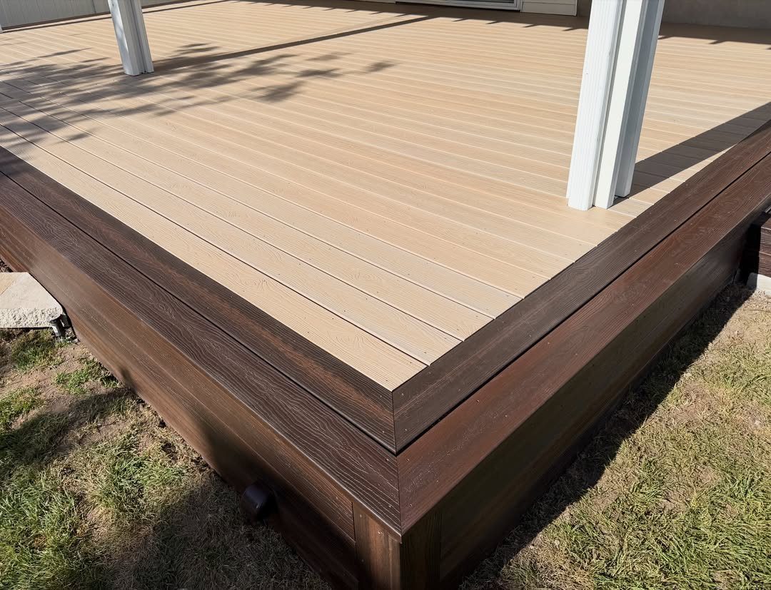 10 Front Yard Decks Ground Level That Welcome Guests First 3 A ground-level deck with light tan planks and dark brown wood-grain trim boards.