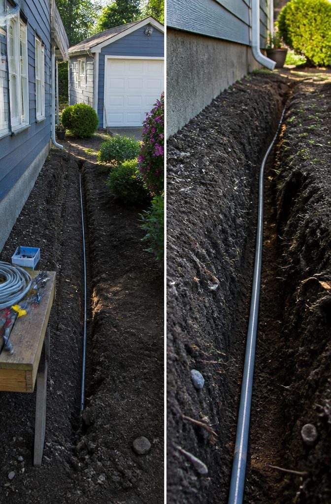 A trench showing electrical wiring setup from a house to a garage.