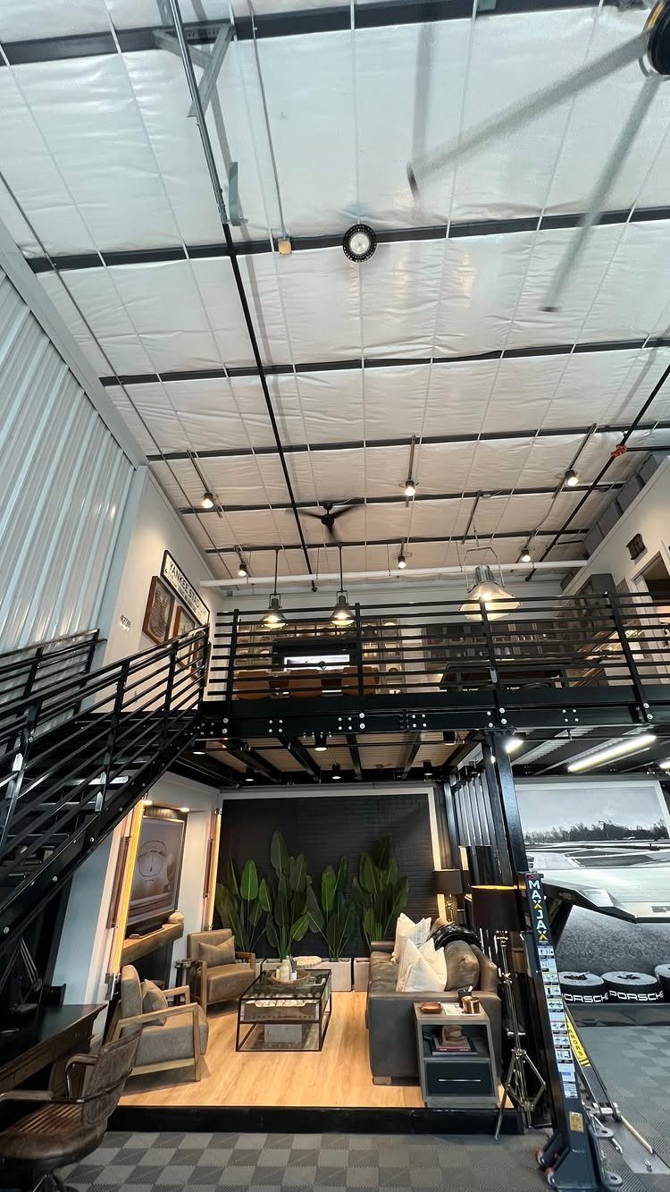 9 Multi Use Garage Ideas for Living, Work, and Play 8 A converted garage living space with a mezzanine level and modern lounge furniture.